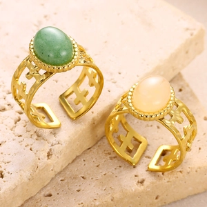 Detail of 18K gold plated stainless steel rings with green and orange natural stones