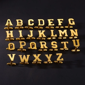 Polished gold initial cufflinks set with A to Z letters on a sleek black background