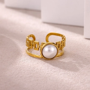 Detailed macro view of 18K gold plated ring with irregular pearl and textured metal finish