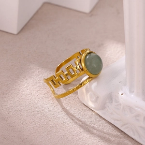 Macro shot of 18K gold plated ring with round green agate stone and geometric hollow band