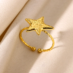 Macro shot of gold starfish ring with textured surface and twisted rope band
