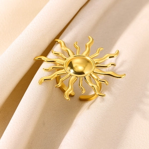 Minimalist sunburst gold open ring with radiant rays on elegant champagne satin backdrop