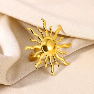 Macro shot of gold sunbeam ring with polished radial curves on silk background