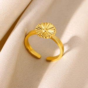 Macro shot of gold daisy flower open ring showing intricate petal textures on silk