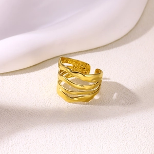 Detail view of gold-plated geometric multi-layer wave ring with organic texture