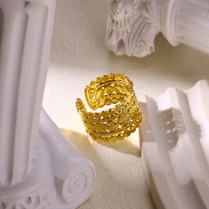 Detail view of gold-plated multi-layer ring featuring sunburst patterns and beaded edges