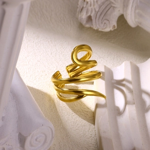 Detailed view of gold multi-layer spiral ring featuring textured hollow engraving details