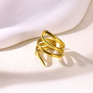Macro shot of gold-plated multi-layer spiral ring with matte textured finish and open design