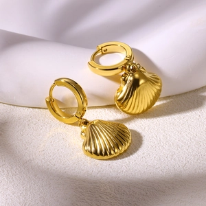 Detailed view of 18K gold plated stainless steel hoop earrings with scallop shell pendants