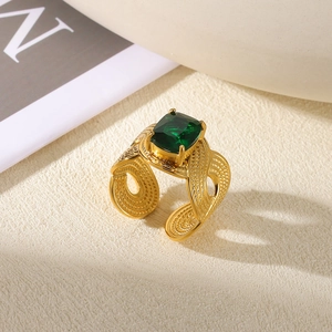 Macro shot of 18K gold plated stainless steel ring with rectangular emerald green zircon