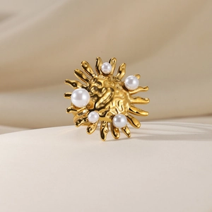 Detailed macro of golden sunflower ring with lava texture and white pearls