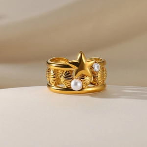 Detail view of gold stainless steel ring with star, pearl, and zircon ocean elements