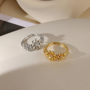Detail view of adjustable daisy flower rings in gold and silver finish with white zircon