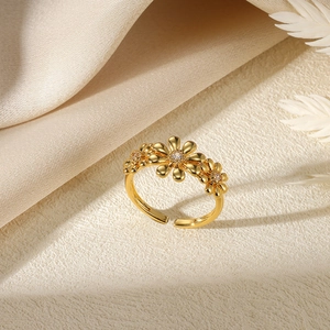Close-up of golden daisy ring with sparkling zircon inlays on a textured fabric