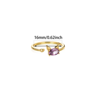 Detail of adjustable gold ring featuring a purple oval crystal and small heart accent