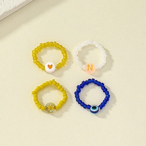 Handmade beaded ring set with heart and star charms in bohemian minimalist style
