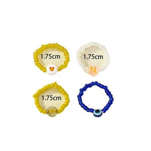 Colorful handmade beaded rings set including heart, star and evil eye charms