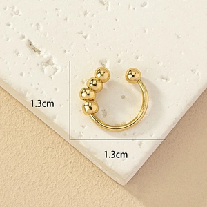 Detail view of 1.3cm gold-plated nose ring with five sliding metal beads in C-shape