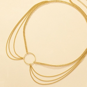 Detailed macro view of multi-layer golden alloy body chain with central metal ring