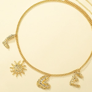 Detail of chunky gold metal waist chain featuring textured moon, sun, and LVE charms
