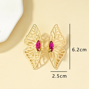 Detail view of 6.2cm gold cutout butterfly wing earrings with pink marquise gemstone