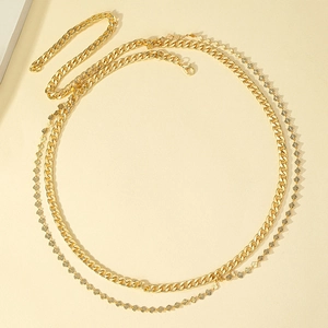 Chic double-layered gold waist chain featuring a curb link and delicate leaf charms
