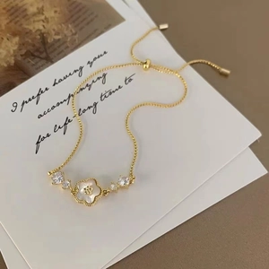 Détail du bracelet ajustable plaqué or 18K avec pendentif en nacre trèfle et zircons