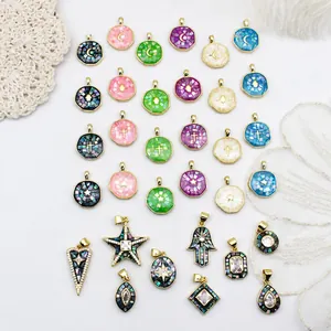 Detailed macro view of 18K gold plated pendants with colorful mosaic shell inlays