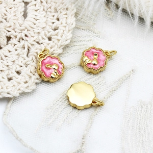 Detailed view of pink enamel bunny pendants with 18K gold plating for jewelry making