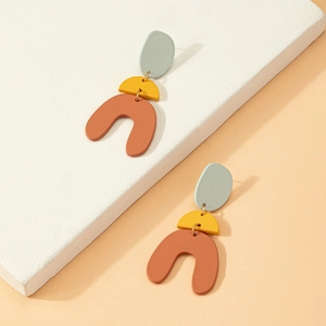 Three-tier geometric bell earrings in green and red resin on a white stone base
