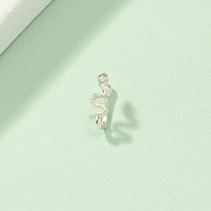Detailed macro view of the silver snake-shaped nose ring with intricate scale textures