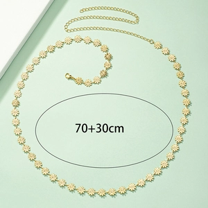 Detail view of a gold daisy flower waist chain with lobster clasp and adjustable 70+30cm link