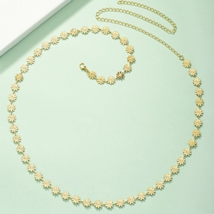 Elegant gold daisy chain belt with adjustable lobster clasp on minimalist green background