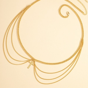 Detail view of multi-layer gold waist chain with crystal cross pendant and lobster clasp