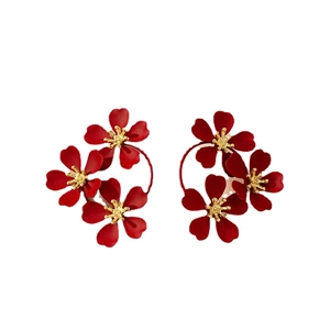 Elegant asymmetrical red flower stud earrings with golden stamens and matte finish