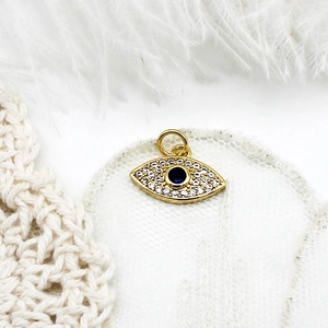 Macro view of 18K gold plated Evil Eye pendant with blue crystal and micro pavé accents