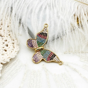 Vue macro d'un pendentif papillon plaqué or 18 carats avec des zircons multicolores