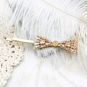 Barrette à cheveux nœud raffinée dorée 18 carats avec zircons pavés et détails de feuilles