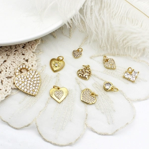 Golden micro-paved heart charms for DIY jewelry making with cubic zirconia stones