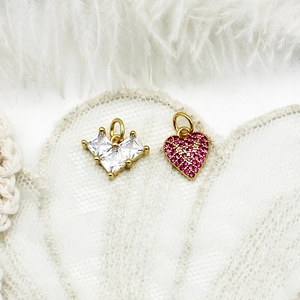 Detail of 18K gold plated heart pendants with clear zircons and red micro-pave crystals