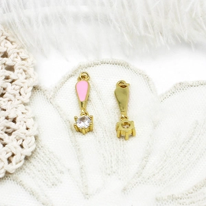 Detail of 18K gold plated ice cream pendants with pink enamel and sparkling white zircon