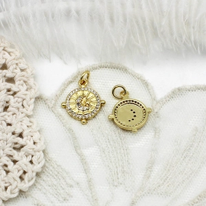 Detailed view of gold plated sun and moon charms with zircon inlays for jewelry making