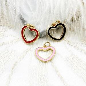 Detailed macro of 18K gold plated heart pendants in red, black, and pink enamel