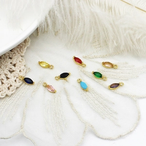 Macro view of colorful marquise charms with golden frames for jewelry making