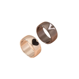 Minimalist gold heart and gunmetal V letter couple rings set in polished stainless steel
