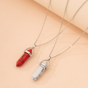 Detail shot of hexagonal bullet stone pendants with natural texture on silver chains