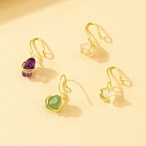 Detail view of four wire-wrapped gold nose clips with colorful raw crystal stones