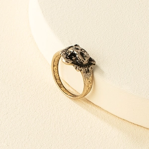 Detailed view of the vintage lion head ring with an antique gold finish and black shadows