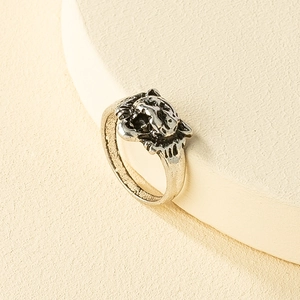 Macro detail of vintage silver lion head embossed ring with retro textures