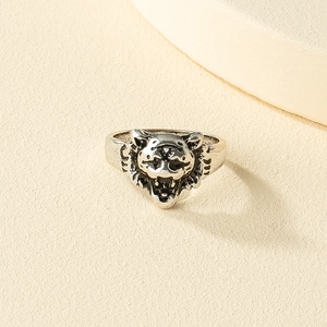 Macro view of vintage silver lion head ring with detailed roaring animal relief